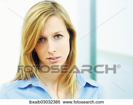 "Young woman wearing a blue blouse, portrait" View Large Photo Image Stock Photography - "Young woman wearing a blue blouse, portrait". Fotosearch
