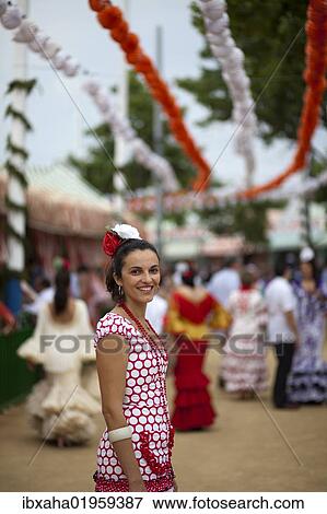 "Young woman wearing a flamenco dress at the """"Feria de Abril"""" April Fair in Seville, Andalucia, Spain, Europe" View Large Photo Image Stock Photo - "Young woman wearing a flamenco dress at the """"Feria de Abril"""" April Fair in Seville, Andalucia, Spain, Europe". Fotosearch