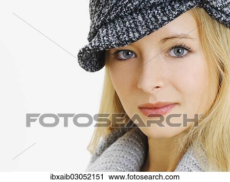 Stock Image - "Young woman wearing a gray cap, portrait". Fotosearch