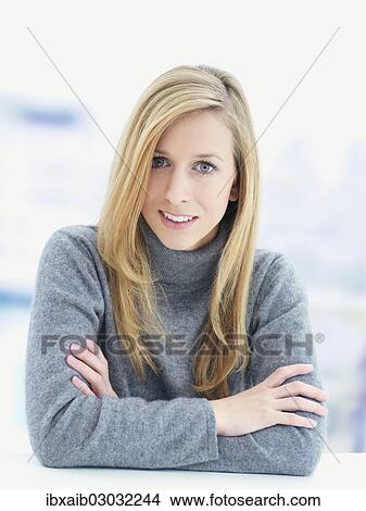 Picture - Young woman wearing a gray sweater. Fotosearch