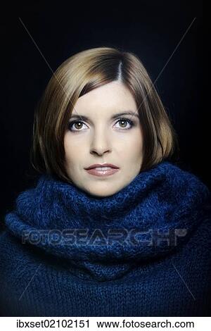Stock Image - "Young woman wearing a turtleneck sweater, portrait". Fotosearch