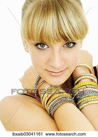 Young woman wearing lots of bangles View Large Photo Image Stock Image - Young woman wearing lots of bangles. Fotosearch