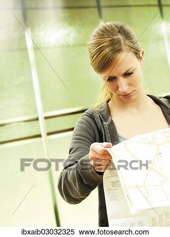 Stock Photography - "Young woman with city map, metro station". Fotosearch