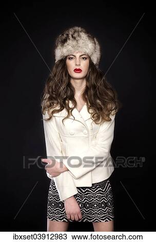 Stock Image - Young woman with fur hat. Fotosearch