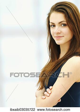 Young woman with her arms crossed View Large Photo Image Stock Image - Young woman with her arms crossed. Fotosearch