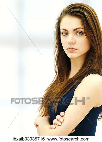 Stock Photograph - Young woman with her arms crossed. Fotosearch