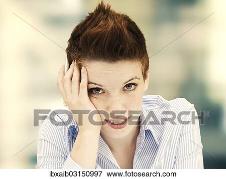 "Young woman with her head propped up, concentrating" View Large Photo Image Stock Photo - "Young woman with her head propped up, concentrating". Fotosearch