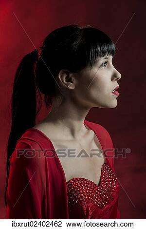 "Young woman with long black hair in a red dress, portrait" View Large Photo Image Stock Image - "Young woman with long black hair in a red dress, portrait". Fotosearch