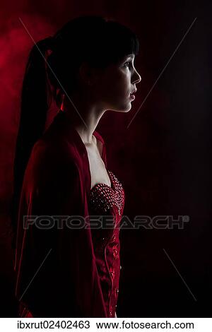 Young woman with long black hair in a red dress View Large Photo Image Stock Image - Young woman with long black hair in a red dress. Fotosearch