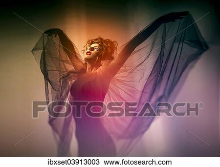 Stock Image - Young woman with wing veil. Fotosearch