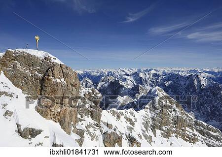 Stock Image - "Zugspitze Mountain, 2962m, with the summit cross, newly restored in 2009, and Jubilaeumsgrat, Jubilee Way, Wetterstein Mountain Range, Werdenfels, Upper Bavaria, Bavaria, Germany, Europe". Fotosearch