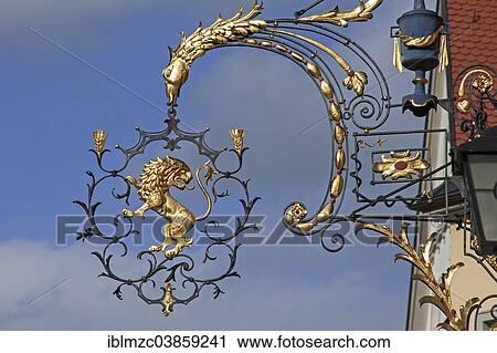 Stock Image - "18th century hanging sign of the former """"Goldener Lowe"""" guesthouse, Wangen, Allgau, Bavaria, Germany, Europe". Fotosearch
