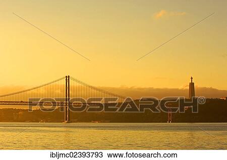 "25 de Abril Bridge, Ponte 25 de Abril, 25th of April Bridge, at dawn, River tagus, Tejo River, Lisbon, Portugal, Europe" View Large Photo Image Stock Image - "25 de Abril Bridge, Ponte 25 de Abril, 25th of April Bridge, at dawn, River tagus, Tejo River, Lisbon, Portugal, Europe". Fotosearch
