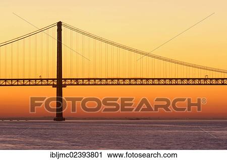 "25 de Abril Bridge, Ponte 25 de Abril, 25th of April Bridge, at dawn, River tagus, Tejo River, Lisbon, Portugal, Europe" View Large Photo Image Stock Image - "25 de Abril Bridge, Ponte 25 de Abril, 25th of April Bridge, at dawn, River tagus, Tejo River, Lisbon, Portugal, Europe". Fotosearch