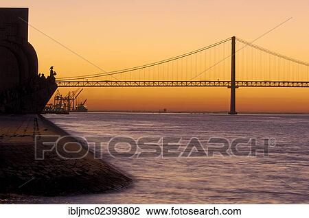 "25 de Abril Bridge, Ponte 25 de Abril, 25th of April Bridge, and Monument to the Discoveries, at dawn, River tagus, Tejo River, Lisbon, Portugal, Europe" View Large Photo Image Stock Image - "25 de Abril Bridge, Ponte 25 de Abril, 25th of April Bridge, and Monument to the Discoveries, at dawn, River tagus, Tejo River, Lisbon, Portugal, Europe". Fotosearch