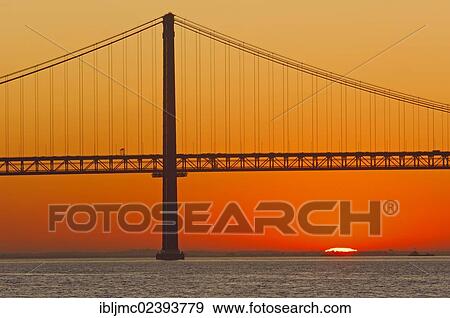 Stock Photo - "25 de Abril Bridge, Ponte 25 de Abril, 25th of April Bridge, at dawn, River tagus, Tejo River, Lisbon, Portugal, Europe". Fotosearch