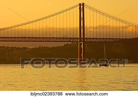 "25 de Abril Bridge, Ponte 25 de Abril, 25th of April Bridge, at dawn, River tagus, Tejo River, Lisbon, Portugal, Europe" View Large Photo Image Stock Photo - "25 de Abril Bridge, Ponte 25 de Abril, 25th of April Bridge, at dawn, River tagus, Tejo River, Lisbon, Portugal, Europe". Fotosearch