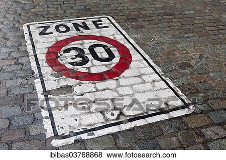 Stock Photo - "30 kph zone, marking for a slow traffic zone on cobblestones, Belgium, Europe". Fotosearch