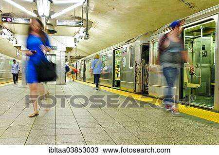 Stock Image - "42nd Street Grand Central Terminal, Number 7 subway platform, commuters, Midtown Manhattan, New York City, USA". Fotosearch