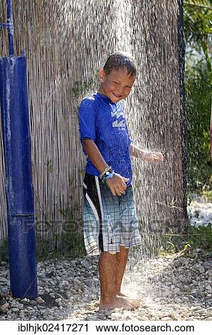 5-year-old boy wearing a blue t-shirt standing under a running shower in a garden, Vassiliki, Lefkas, Greece, Europe View Large Photo Image Stock Image - 5-year-old boy wearing a blue t-shirt standing under a running shower in a garden, Vassiliki, Lefkas, Greece, Europe. Fotosearch