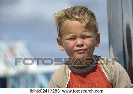 Stock Image - 5-year-old boy with a sceptical expression. Fotosearch