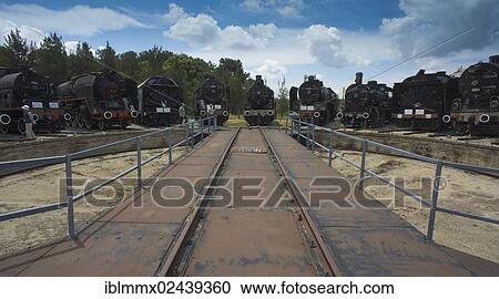Stock Image - "8 locomotives and a snow blower standing in front of the turntable, Camlik Railway Museum, Camlik, Turkey, Asia". Fotosearch