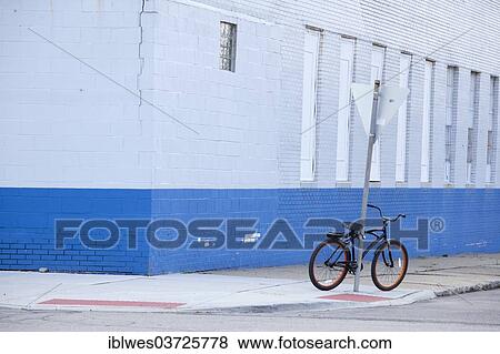 Stock Photo - "A bicycle parked on a street corner, Detroit, Michigan, United States, North America". Fotosearch