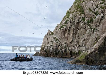 Stock Photography - "A boat with tourists off Cape Achen, Chukotka, Russia, Europe". Fotosearch