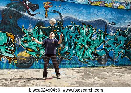 "A boy, 10 years, is playing with his football in front of a graffiti covered wall, football ground, Cologne, North Rhine-Westphalia, Germany, Europe, PublicGround, Europe" View Large Photo Image Stock Photograph - "A boy, 10 years, is playing with his football in front of a graffiti covered wall, football ground, Cologne, North Rhine-Westphalia, Germany, Europe, PublicGround, Europe". Fotosearch