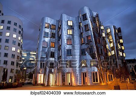 "A building by American architect Frank O. Gehry at night, Neuer Zollhof building complex, Medienhafen district, Duesseldorf, North Rhine-Westphalia, Germany, Europe" View Large Photo Image Stock Photo - "A building by American architect Frank O. Gehry at night, Neuer Zollhof building complex, Medienhafen district, Duesseldorf, North Rhine-Westphalia, Germany, Europe". Fotosearch