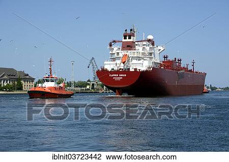 "A cargo ship is towed from the Gdansk shipyard by a tug boat, Gdansk, Pomeranian Voivodeship, Poland, Europe" View Large Photo Image Stock Image - "A cargo ship is towed from the Gdansk shipyard by a tug boat, Gdansk, Pomeranian Voivodeship, Poland, Europe". Fotosearch