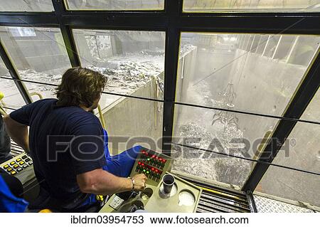 "A crane operator is supervising the transport of waste to the incinerators in a waste incineration plant, Essen-Karnap, North Rhine-Westphalia, Germany, Europe" View Large Photo Image Stock Image - "A crane operator is supervising the transport of waste to the incinerators in a waste incineration plant, Essen-Karnap, North Rhine-Westphalia, Germany, Europe". Fotosearch