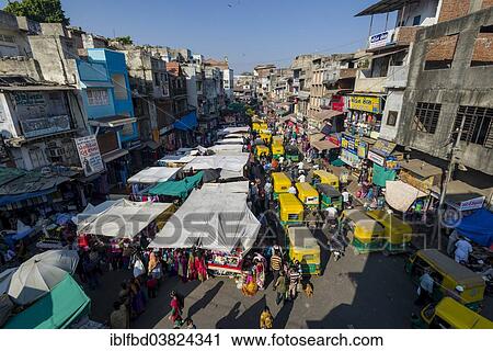 Stock Image - "A crowded street with shops and traffic jam in the old city market area, Ahmedabad, Gujarat, India, Asia". Fotosearch