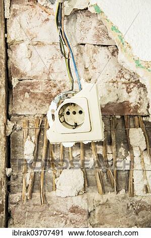 "A damaged power socket hanging from a wall in a dilapidated house, Hamburg, Hamburg, Germany, Europe" View Large Photo Image Stock Image - "A damaged power socket hanging from a wall in a dilapidated house, Hamburg, Hamburg, Germany, Europe". Fotosearch