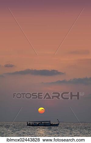 "A Dohni, a Maldivian boat sailing in front of a sunset, North Male Atoll, Republic of the Maldives, Maldive Islands, Indian Ocean, Asia" View Large Photo Image Stock Photo - "A Dohni, a Maldivian boat sailing in front of a sunset, North Male Atoll, Republic of the Maldives, Maldive Islands, Indian Ocean, Asia". Fotosearch