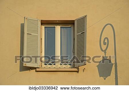"A facade in Ajaccio with a lone window and the shadow of a street lamp illuminated by warm morning light. Ajaccio is the capital of the mediterranean island of Corsica, France. It is in the department of Corse-du-Sud, Ajaccio, Corsica, France, Europe" View Large Photo Image Stock Image - "A facade in Ajaccio with a lone window and the shadow of a street lamp illuminated by warm morning light. Ajaccio is the capital of the mediterranean island of Corsica, France. It is in the department of Corse-du-Sud, Ajaccio, Corsica, France, Europe". Fotosearch