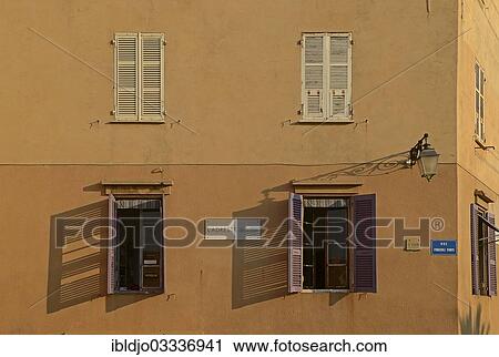 "A facade in Ajaccio with open and closed windows illuminated by warm morning light. Ajaccio is the capital of the mediterranean island of Corsica, France. It is in the department of Corse-du-Sud, Ajaccio, Corsica, France, Europe" View Large Photo Image Stock Image - "A facade in Ajaccio with open and closed windows illuminated by warm morning light. Ajaccio is the capital of the mediterranean island of Corsica, France. It is in the department of Corse-du-Sud, Ajaccio, Corsica, France, Europe". Fotosearch