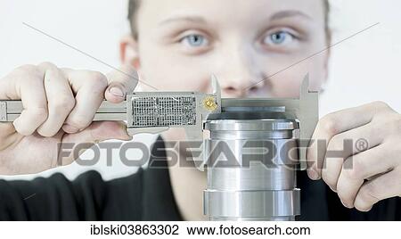"A female cutting machine operator trainee is measuring a casing with a caliper, training center of the engine and turbine manufacturer MAN Diesel and Turbo SE, Augsburg, Bavaria, Germany, Europe" View Large Photo Image Stock Image - "A female cutting machine operator trainee is measuring a casing with a caliper, training center of the engine and turbine manufacturer MAN Diesel and Turbo SE, Augsburg, Bavaria, Germany, Europe". Fotosearch