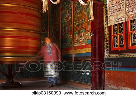 "A female devotee spinning a large prayer wheel, Boudhanath, Kathmandu, Kathmandu District, Bagmati Zone, Nepal, Asia" View Large Photo Image Stock Image - "A female devotee spinning a large prayer wheel, Boudhanath, Kathmandu, Kathmandu District, Bagmati Zone, Nepal, Asia". Fotosearch