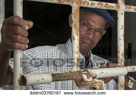 "A former prisoner standing behind a door with iron bars, former Tarrafal concentration camp or Campo do Tarrafal, Tarrafal, Santiago, Cape Verde, Africa" View Large Photo Image Stock Image - "A former prisoner standing behind a door with iron bars, former Tarrafal concentration camp or Campo do Tarrafal, Tarrafal, Santiago, Cape Verde, Africa". Fotosearch