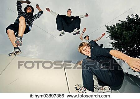 Stock Photograph - "A group of freerunners jumping, obstacle course". Fotosearch