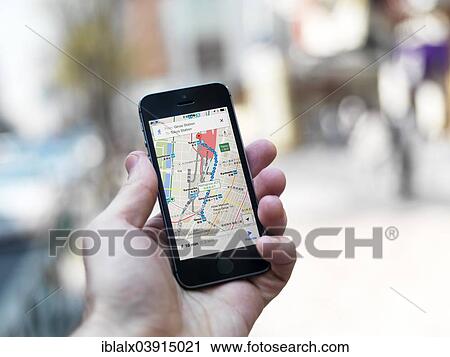 A Hand Holding An Iphone Displaying The Google Maps Gps