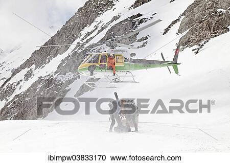 "A helicopter is landing on the glacier at Cavardiras to transport people into the valley, Graubunden, Switzerland, Europe" View Large Photo Image Stock Image - "A helicopter is landing on the glacier at Cavardiras to transport people into the valley, Graubunden, Switzerland, Europe". Fotosearch