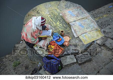 "A Hindu devotee reading a holy book along one of the ghats, Pashupatinath, Kathmandu, Kathmandu District, Bagmati Zone, Nepal, Asia" View Large Photo Image Stock Image - "A Hindu devotee reading a holy book along one of the ghats, Pashupatinath, Kathmandu, Kathmandu District, Bagmati Zone, Nepal, Asia". Fotosearch