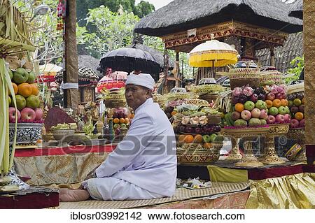 "A Hindu priest amidst sacrificial offerings at a temple ceremony, Pura Desa Temple, Ubud, Bali, Indonesia, Asia" View Large Photo Image Stock Image - "A Hindu priest amidst sacrificial offerings at a temple ceremony, Pura Desa Temple, Ubud, Bali, Indonesia, Asia". Fotosearch