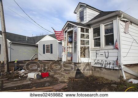 Stock Image - "A house heavily damaged by Hurricane Sandy, with a message from the owner, Union Beach, New Jersey, United States, North America". Fotosearch