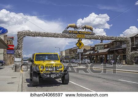Stock Photo - "A jeep in front of the world's largest arch made of wapiti antlers, Afton, Wyoming, United States, North America". Fotosearch