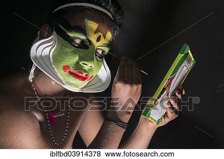 "A Katakali artist is applying the make-up of the character Arjun for the Santhana Gopalam play during a temple festival, Ayroor, Kerala, India, Asia" View Large Photo Image Stock Photo - "A Katakali artist is applying the make-up of the character Arjun for the Santhana Gopalam play during a temple festival, Ayroor, Kerala, India, Asia". Fotosearch