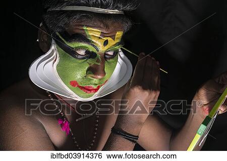 "A Katakali artist is applying the make-up of the character Arjun for the Santhana Gopalam play during a temple festival, Ayroor, Kerala, India, Asia" View Large Photo Image Stock Photograph - "A Katakali artist is applying the make-up of the character Arjun for the Santhana Gopalam play during a temple festival, Ayroor, Kerala, India, Asia". Fotosearch