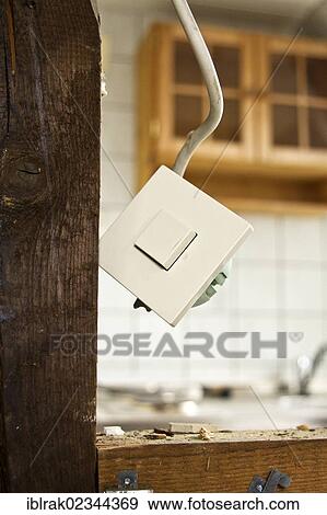 Stock Photo - "A light switch hanging loosely on a cable in a demolished house, Germany, Europe". Fotosearch